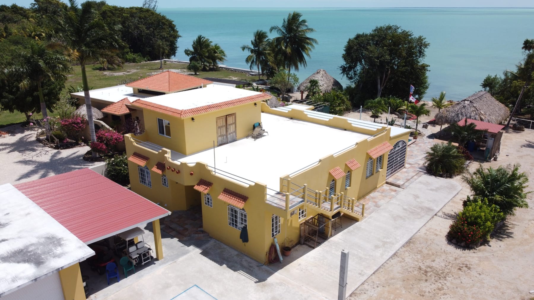 Aerial view of the 47 Consejo Beach Trail estate, pool and Corozal Bay