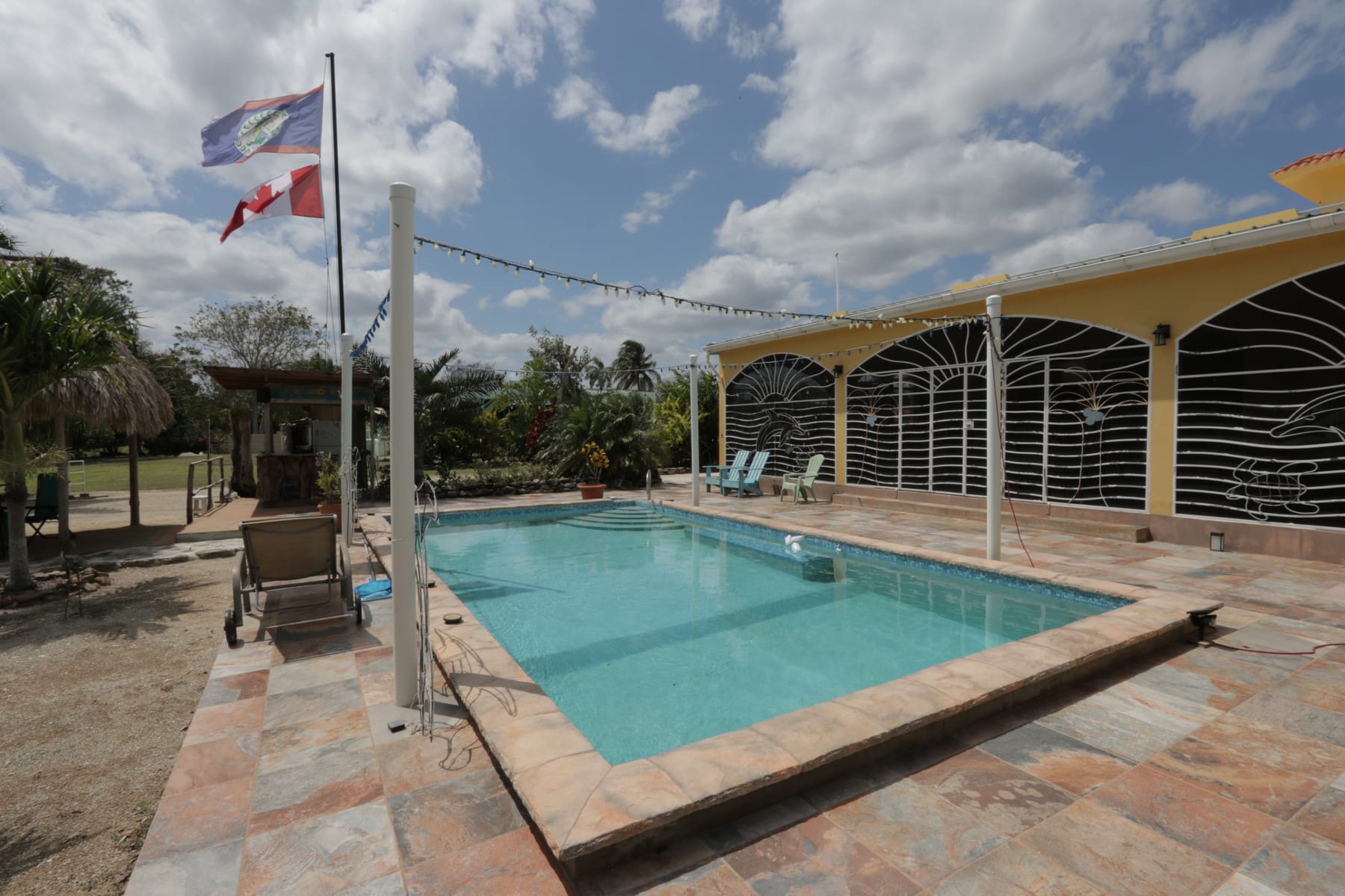 Pool and sun loungers overlooking Corozal Bay at 47 Consejo Beach Trail