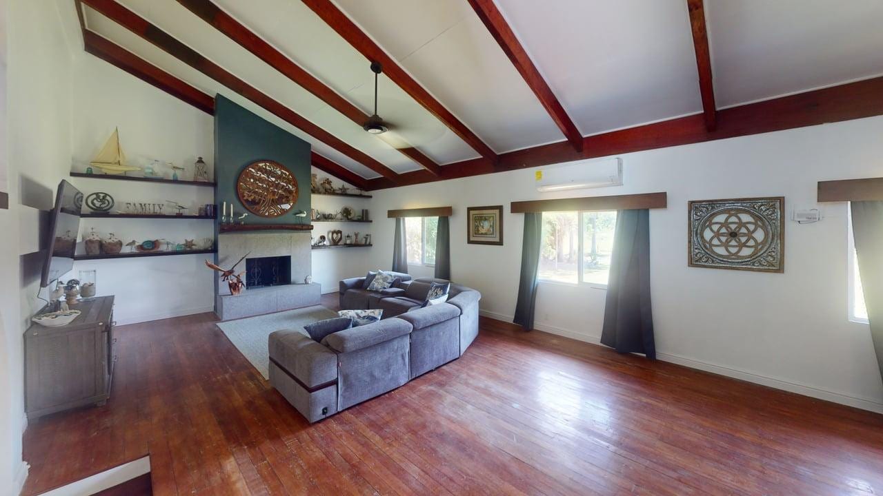 Open living room with vaulted wood-beam ceiling at 16 Tamay Trail